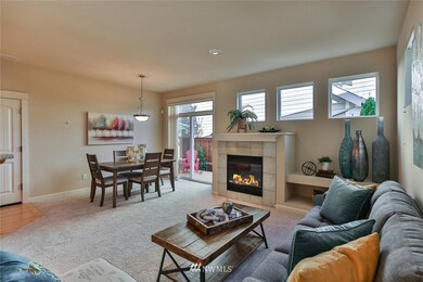 Relax and enjoy the spacious living and dining area and the beautiful gas fireplace.  the sliding glass doors open to the private, fenced back yard.