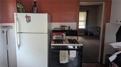 Kitchen featuring dark carpet and white appliances