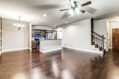 Corner of living room looking onto kitchen and hal