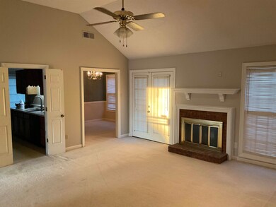 Unfurnished living room featuring light carpet, a 
