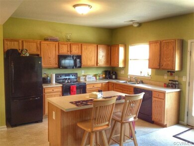 Open kitchen with island and all black appliances