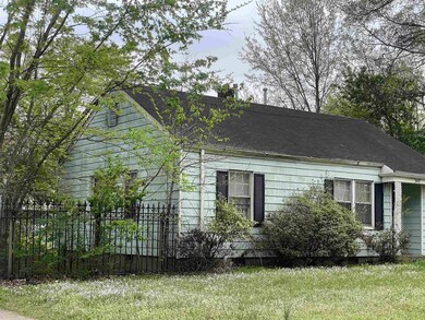 View of side of home with fence, a yard, a chimney