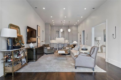 Living area with wood finished floors and recessed lighting