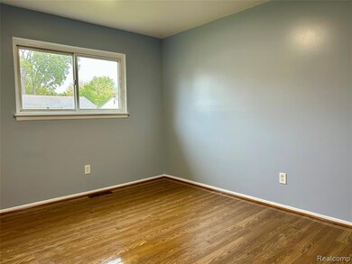 Unfurnished room featuring wood finished floors and baseboards