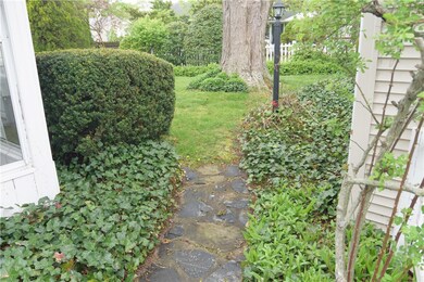 WALK TO BACKYARD WITH MANY PLANTINGS