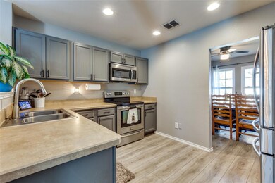 Kitchen featuring light wood-type flooring, stainl