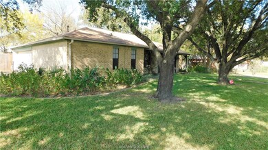 Beautiful mature trees surround home.