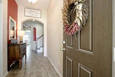 Foyer featuring arched walkways and wood finished