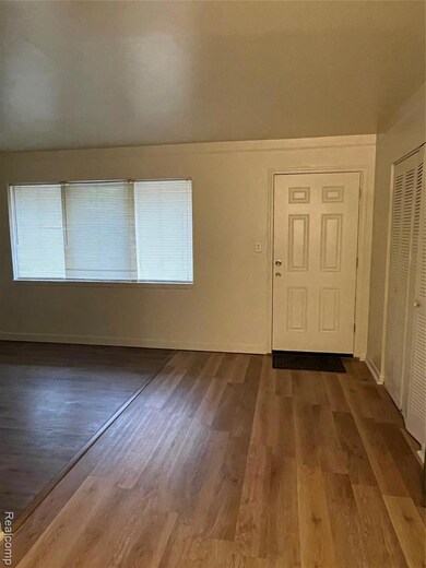 Entrance foyer featuring dark wood-style flooring and baseboards