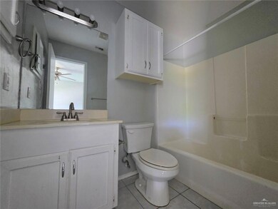 Full bath featuring toilet, visible vents, baseboards, tile patterned flooring, and vanity