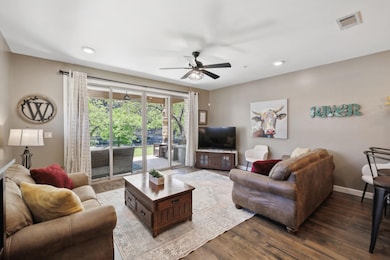 Living area with a ceiling fan, baseboards, reces