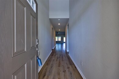 Hall with wood finished floors and recessed light