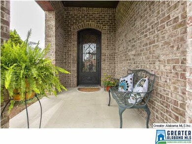 VIEW OF FRONT COVERED PORCH WITH BEAUTIFUL IRON DO