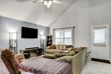 The living area is open to the kitchen and dining area and features a picture window with a view of the backyard.