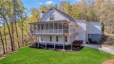 Rear view of house with concrete driveway, a chimn