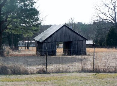 Large barn with some fencing. 
