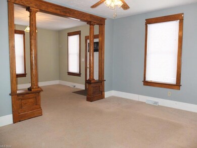 Living room with wood columns.