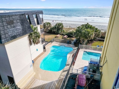 View of swimming pool featuring a beach view and a