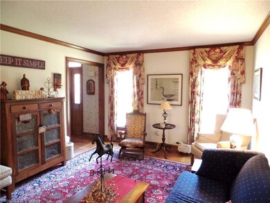 Formal living room, with hardwoods and stained woodwork that brings out the rich detail of the wood.
