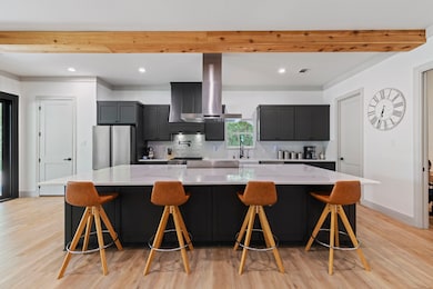 Features a large center island with quartz counter