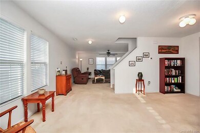 Foyer and dining room lead to living room and stai