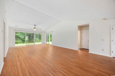 Spare room featuring ceiling fan, vaulted ceiling,