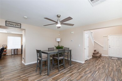 Dining space with wood finished floors, ceiling fa