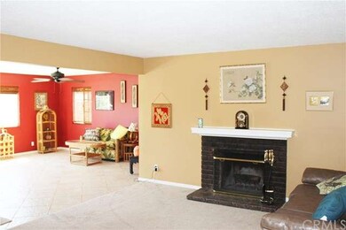 Living room with fireplace opens onto family room.