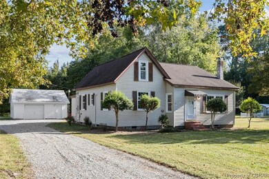 View of front of house with a garage and a front y