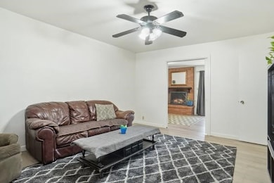 Living room featuring a lit fireplace and light wood-type flooring