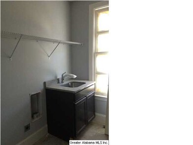 Laundry room w mop sink and cabinet