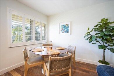 Bedroom with ceiling fan, a wall mounted AC, wood finished floors, and baseboards