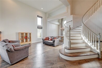 Living room with stairs, hardwood / wood-style flo