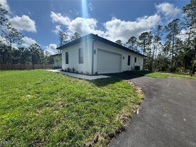 View of side of property with aphalt driveway