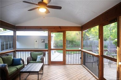 Screened in porch with shades that pull down and T