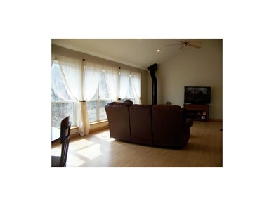 Vaulted Ceiling, Built Ins, And Ceiling Fan In Gre