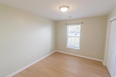 Unfurnished bedroom with light wood finished floors and a closet
