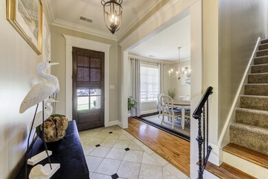 Travertine Tiled Foyer entrance featuring a Fab ch
