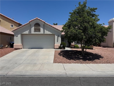 View of front of home with a garage, stucco siding