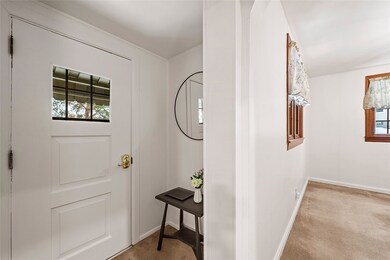 Pretty foyer offers a place for coats and wet shoe