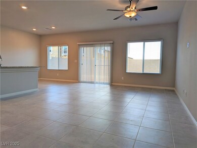 Unfurnished living room featuring light tile patte