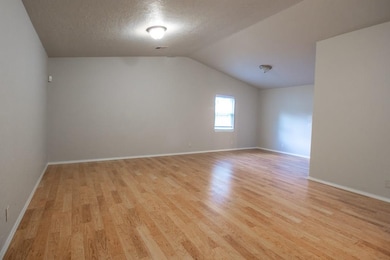 Living room space with attached formal dining space.