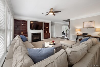 Living room with carpet flooring, built in shelves