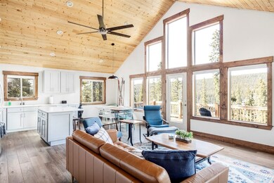 Living room featuring high vaulted ceiling, wood-t