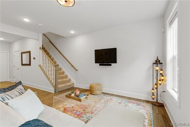 Spacious open-concept living area with recessed li