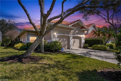 View of front of home with an attached garage, a t
