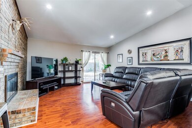 Living room with lofted ceiling, wood-type floorin