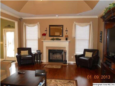 Den with wood burning fireplace.