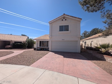 View of front facade with an attached garage, stuc