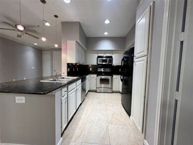 The kitchen has tile flooring, granite countertops